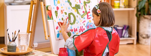 Banner, girl finger painting on easel