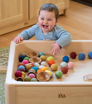 A baby playing at the Low Sensory table