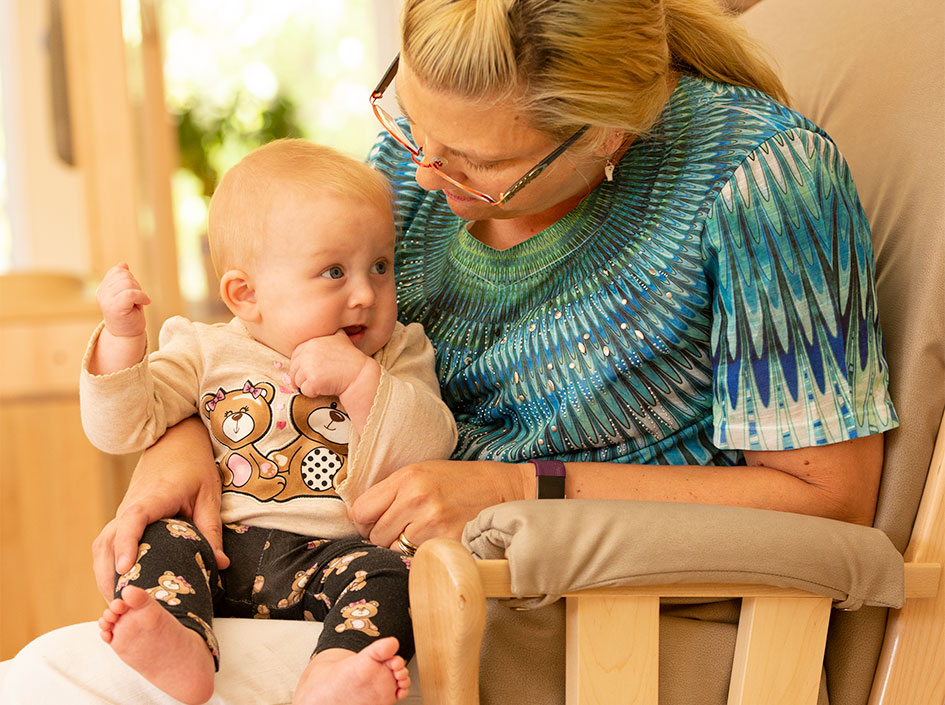 An adult holding an infant.