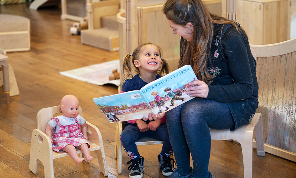 A teacher reading to a child.