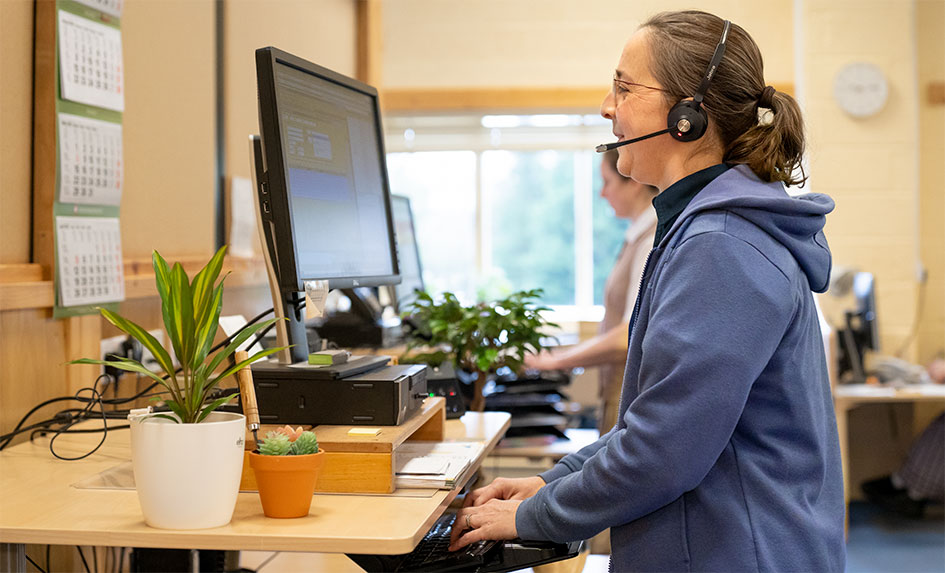 A Community Playthings account manager talking on the telephone to a customer. 