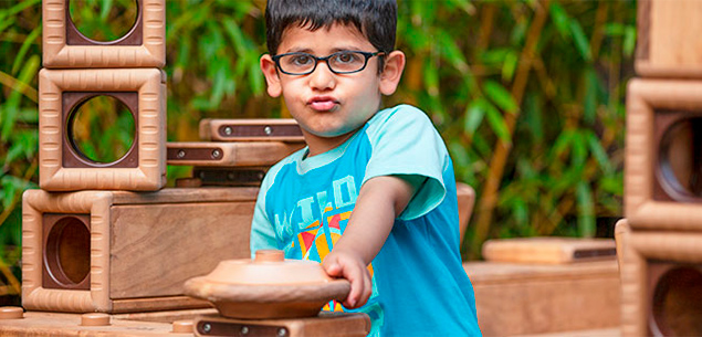 boy with blue shirt turning an Outlast steering wheel
