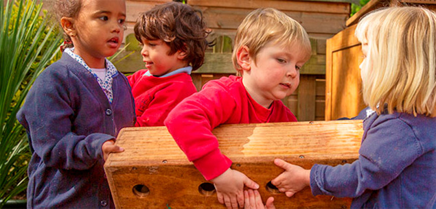 3 nursery aged children hauling Outlast block together