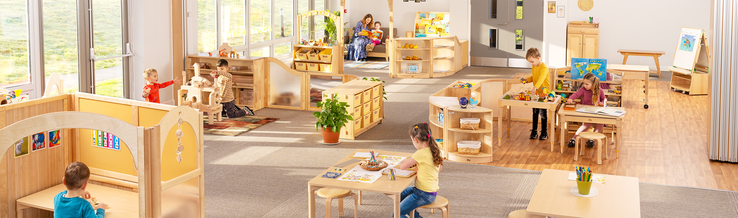 Children in a classroom with wooden furniture
