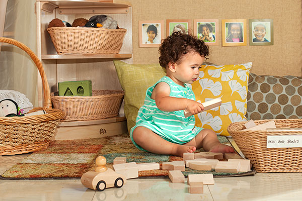 toddler playing with mini unit blocks