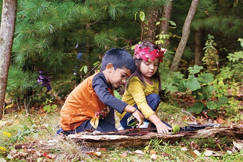 Two children are building bark boats