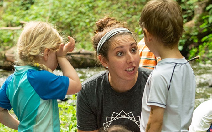 An early years teacher is interacting with children