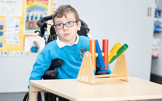 boy in wheelchair at table