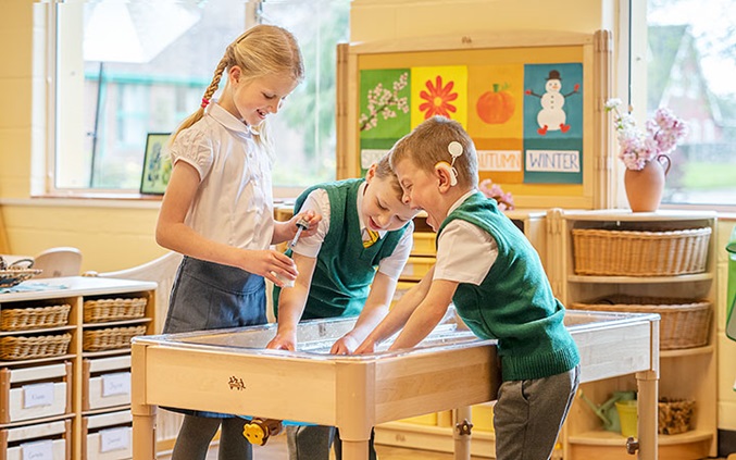 kids with sand and water table