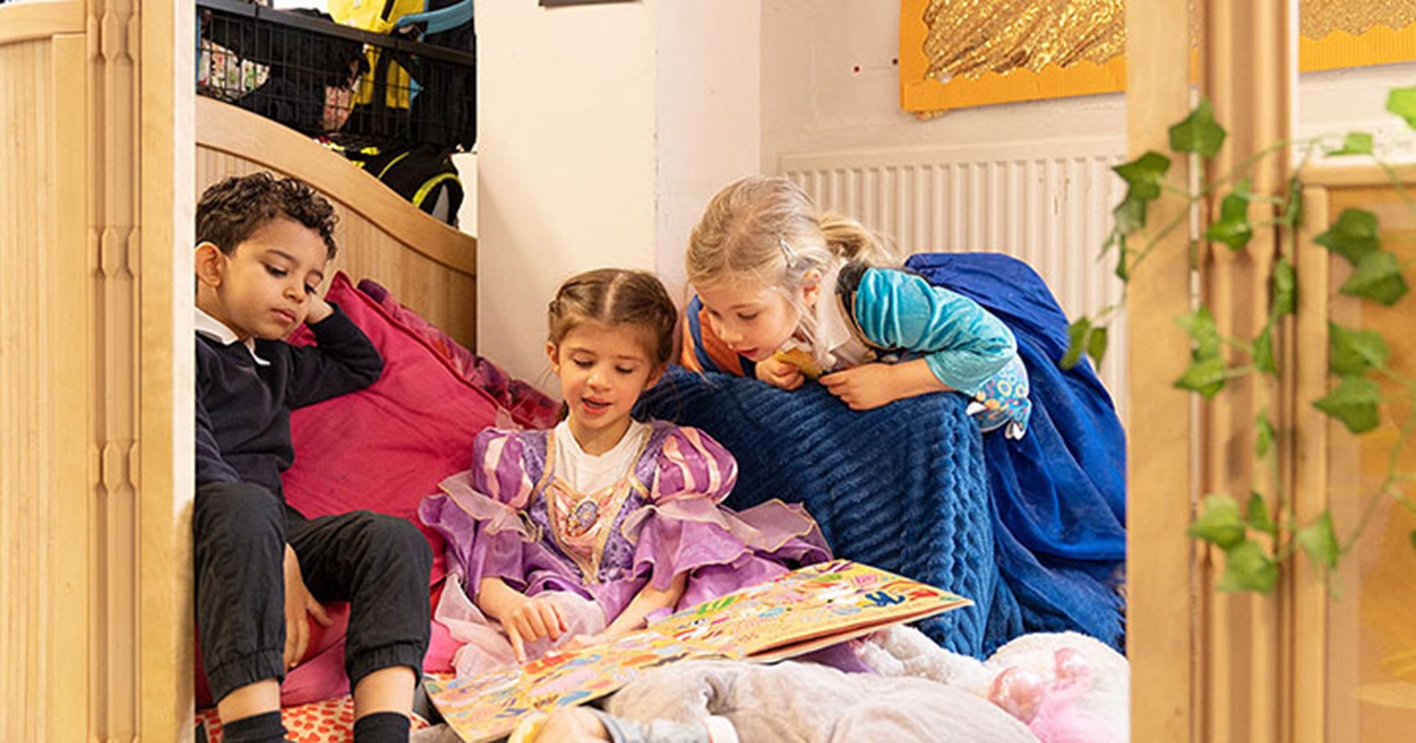 3 kids looking at book