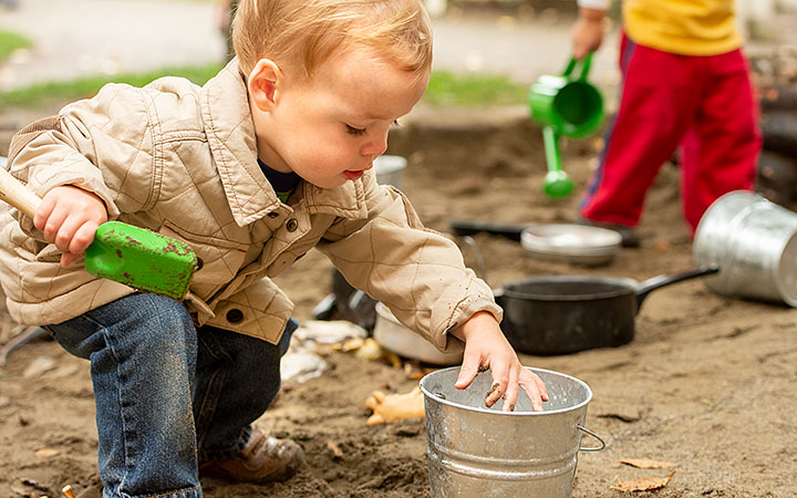 child playing in sandbox