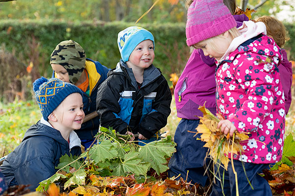 children making leaf pile