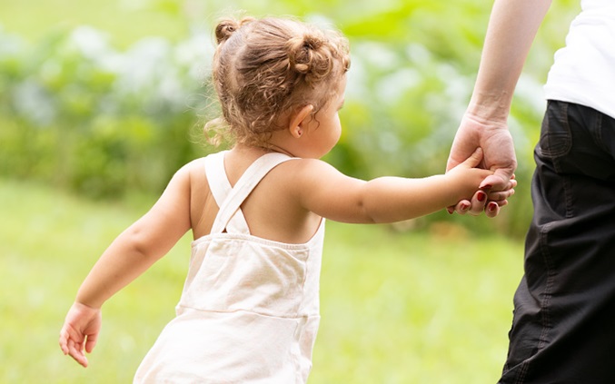 Girl walking with her hand being held