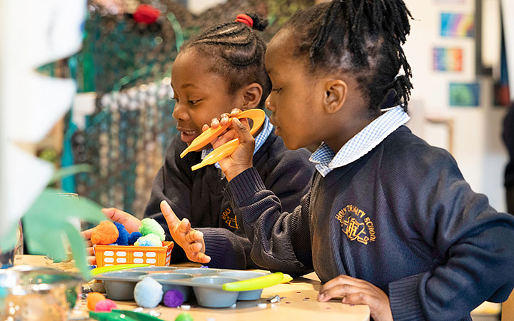 Reception age children playing with hollow blocks