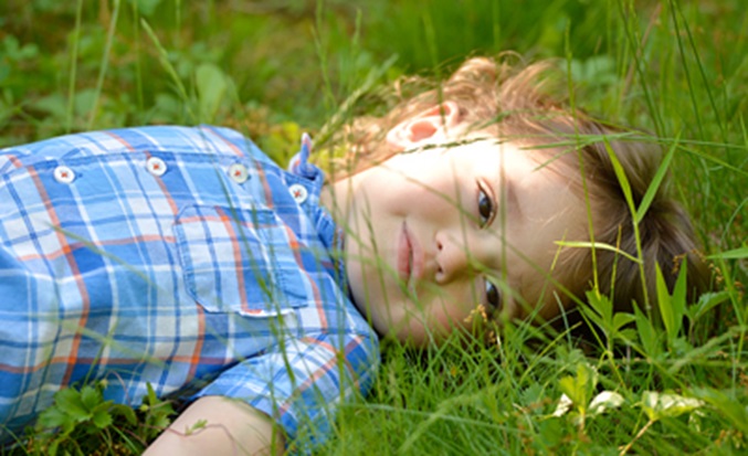 girl lying in the grass