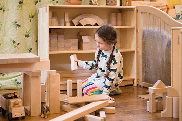 little girl stacking blocks