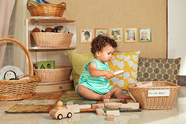 little girl playing with mini unit blocks