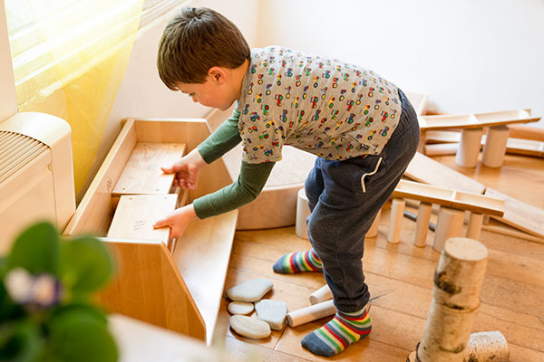 boy tidying up mini hollow blocks