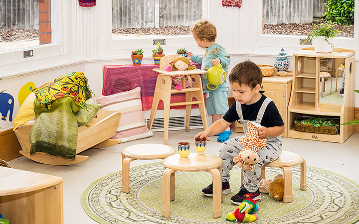 child using stool as table