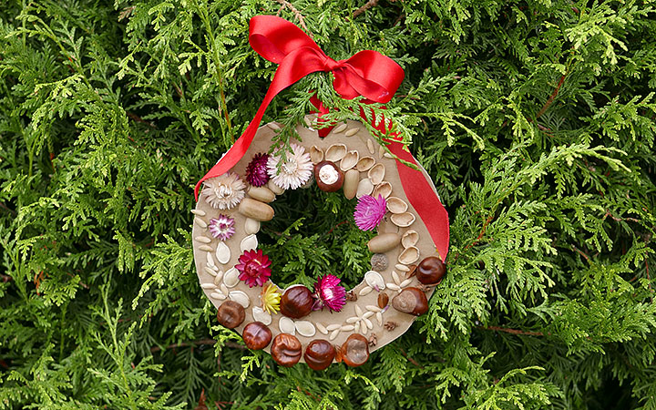 Finished wreath hanging with red ribbon