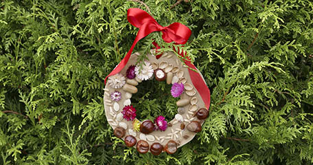 Finished wreath hanging with red ribbon