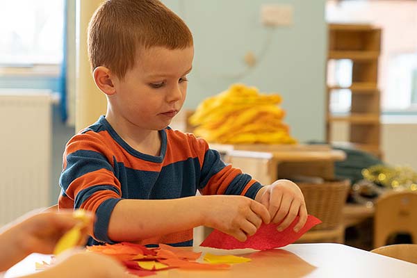 boy tearing red tissue