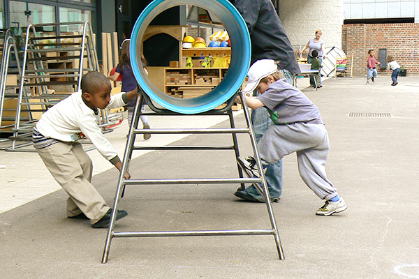 two boys moving a play structure together