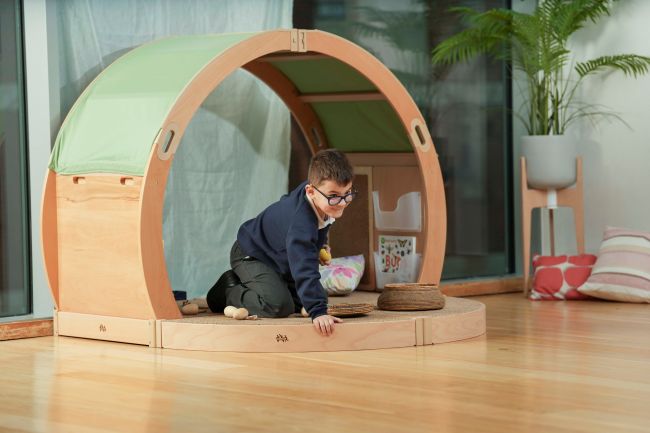 A school-aged boy plays in a calm corner