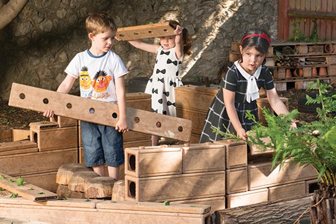 3 children playing with outlast outdoor blocks