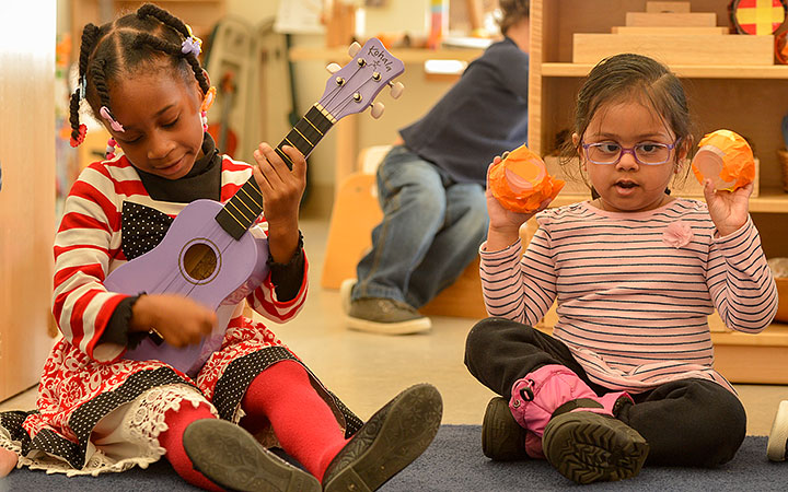 Two small children with musical instruments