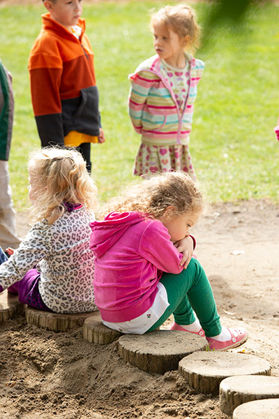 children around a sandbox