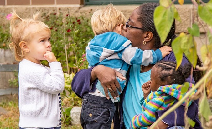 teacher hugging child