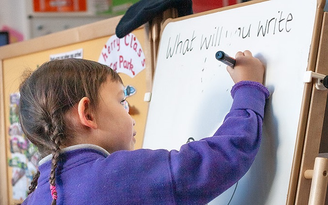 Child writing on a whiteboard