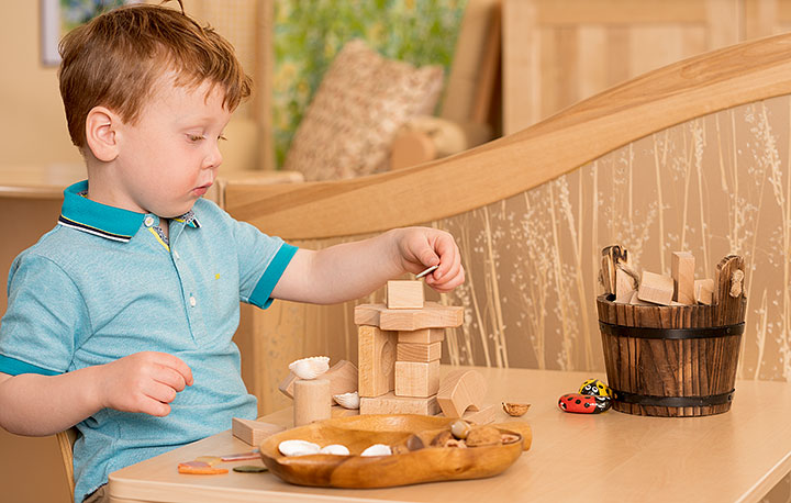 Small child playing with wooden blocks