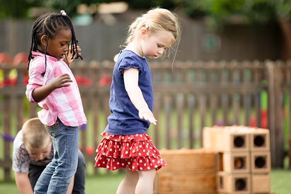 girls balancing on Outlast blocks