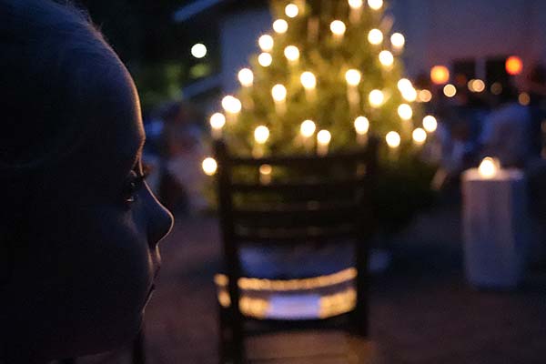 Candlelit tree with child’s face