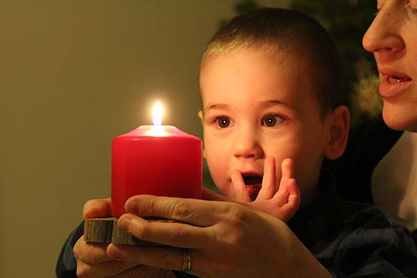 Child and mother with red candle