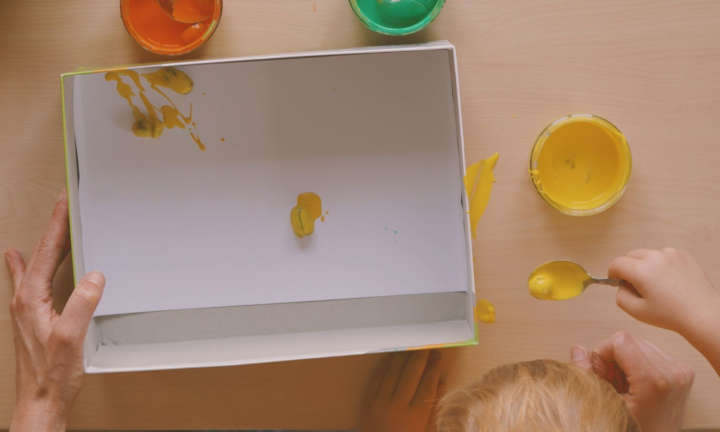 Cardboard box with paper, acorns with paint are added