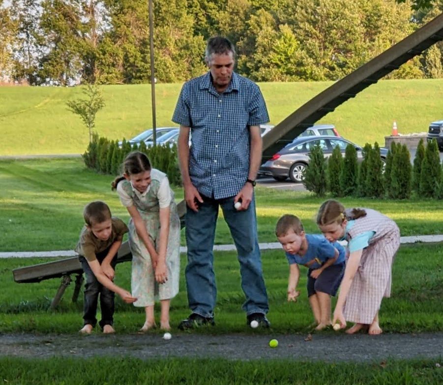 Kids and teacher playing games outdoors