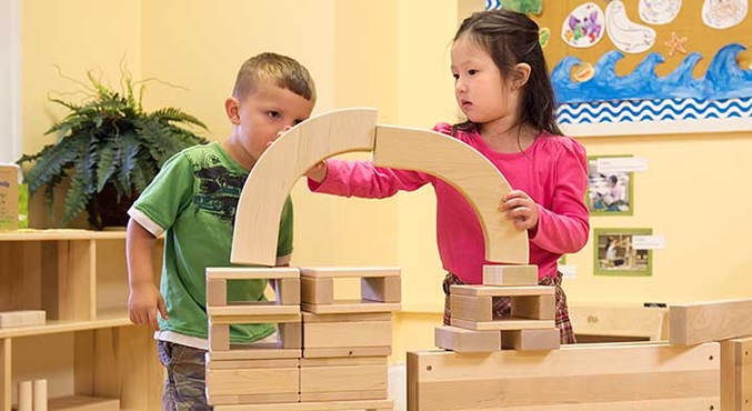 A boy and a girl playing with blocks