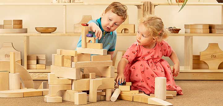 Girl and boy toddlers playing with blocks