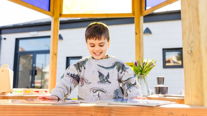 A boy at an outdoor workspace