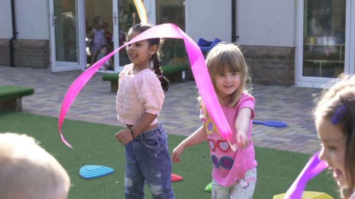 Children playing with ribbons in the outdoor area
