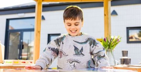 A boy at an outdoor workspace