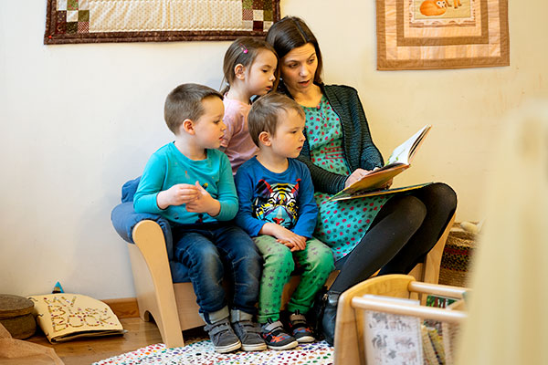 teacher reading stories to children