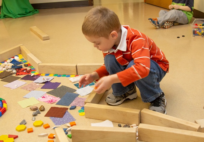Boy with blocks and loose parts