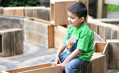 Boy plays with hollow blocks