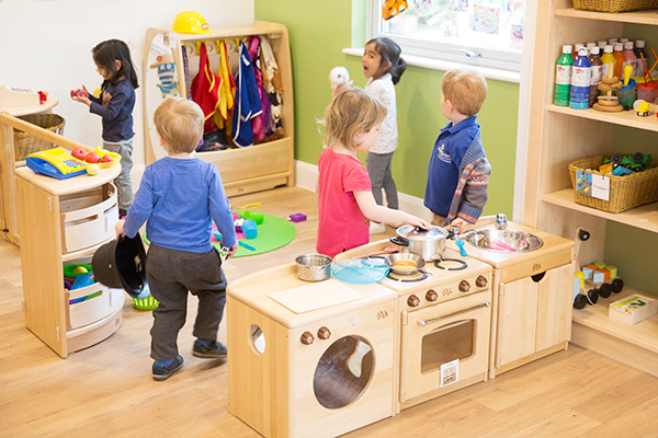 children interacting in the home corner