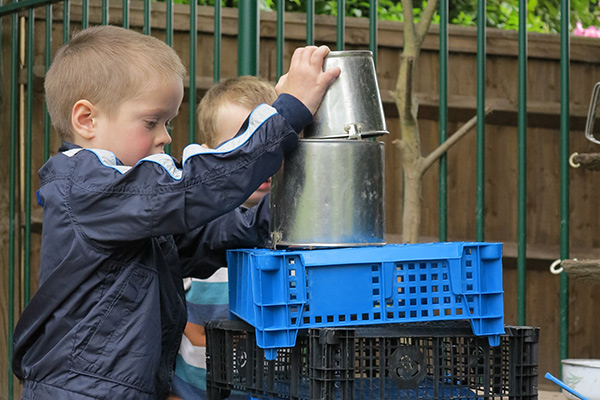 little boy stacking crates