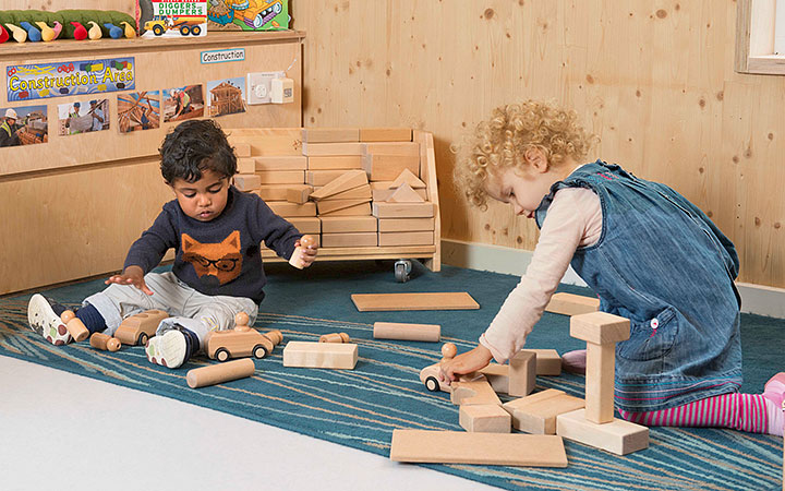 Two children doing solitary independent play